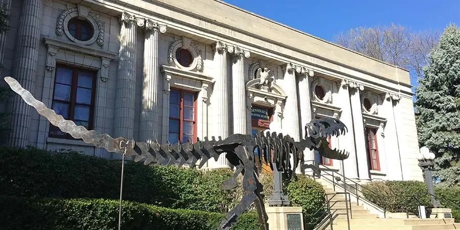 Metal dinosaur skeleton sculpture in front of the Dinosaur Discovery Museum in Kenosha, Wisconsin.