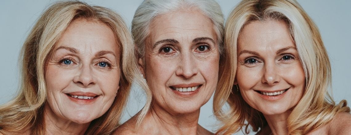 Three smiling mature women showcasing healthy, radiant skin.