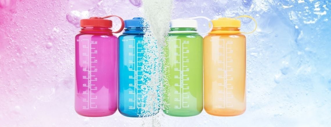 Four colorful reusable water bottles with hydration powder pouring down.