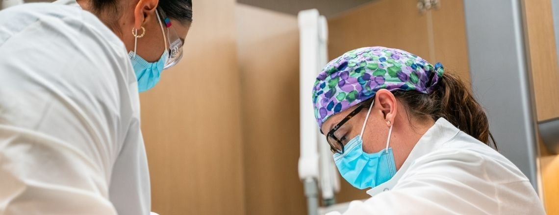 dentist and dental assistant examining a patient