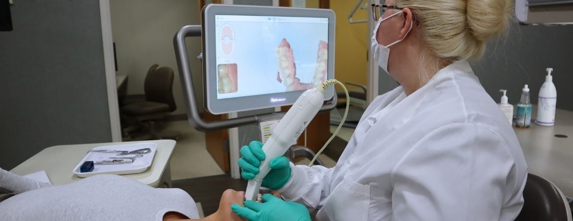 dental assistant using a dental scanner for digital impressions on a patient