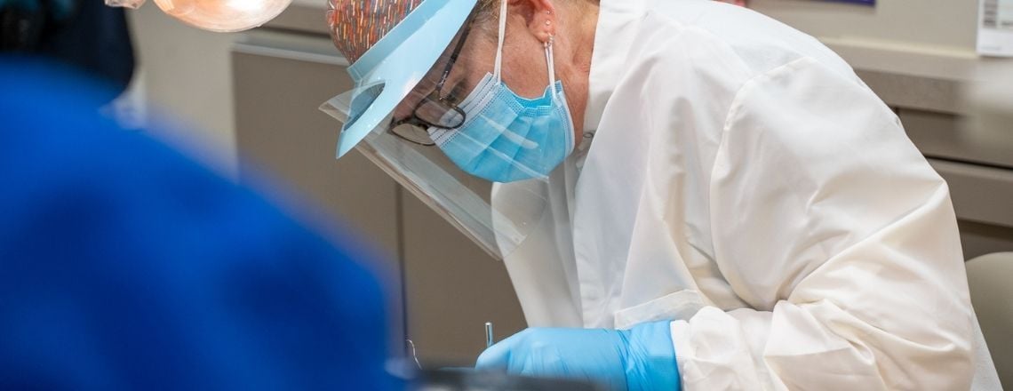 dental hygienist performing a cleaning on a patient