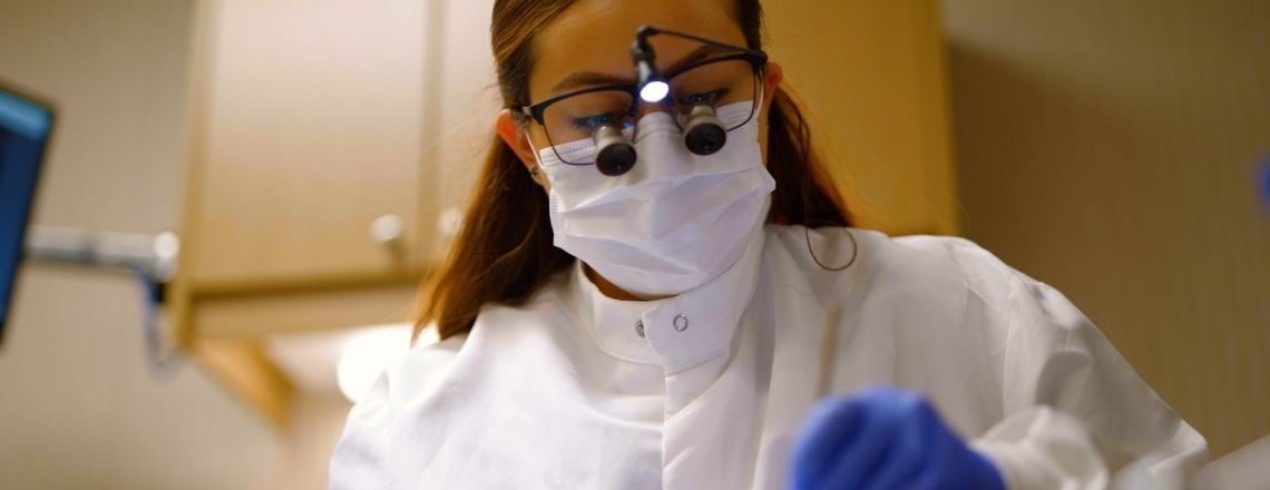 dental hygienist examining a patient