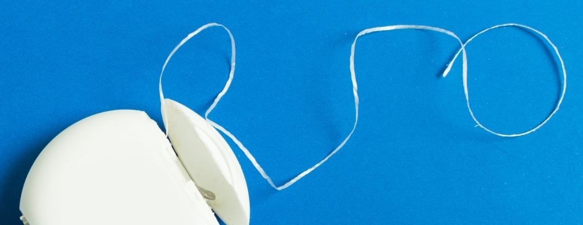 close up of floss on blue background