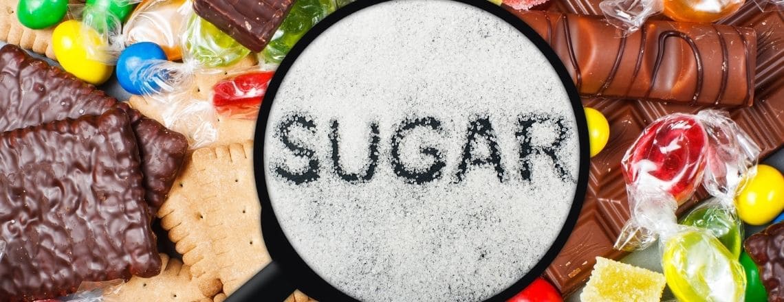 candy laid out on a table with sugar in a pile and sugar spelled out in the middle