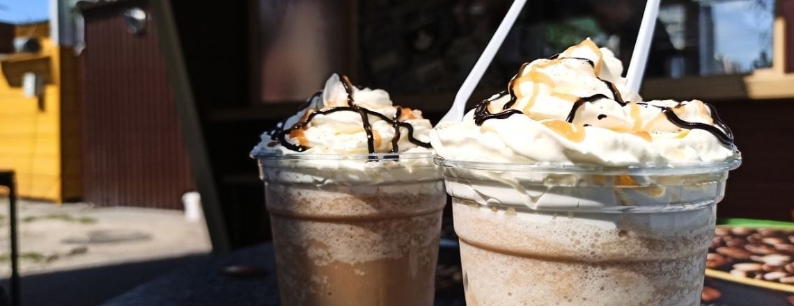 frozen coffee drinks with whipped cream and chocolate and caramel sauce on top