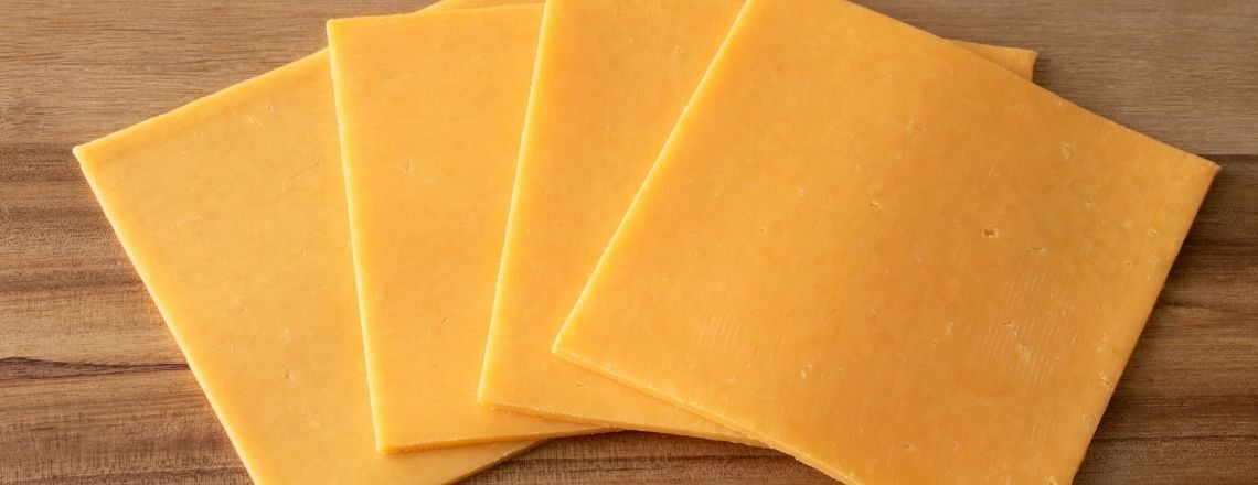cheddar cheese slices laid out on a table