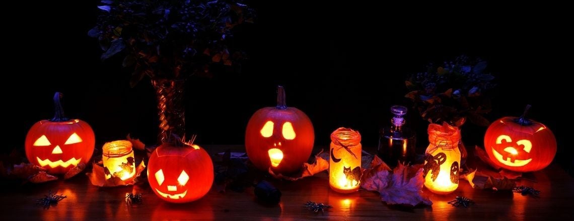 jack-o-lanterns lit up on a dark night