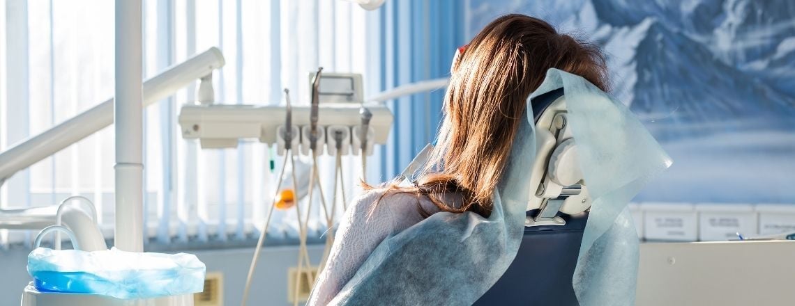 woman in a dental chair getting a dental procedure done