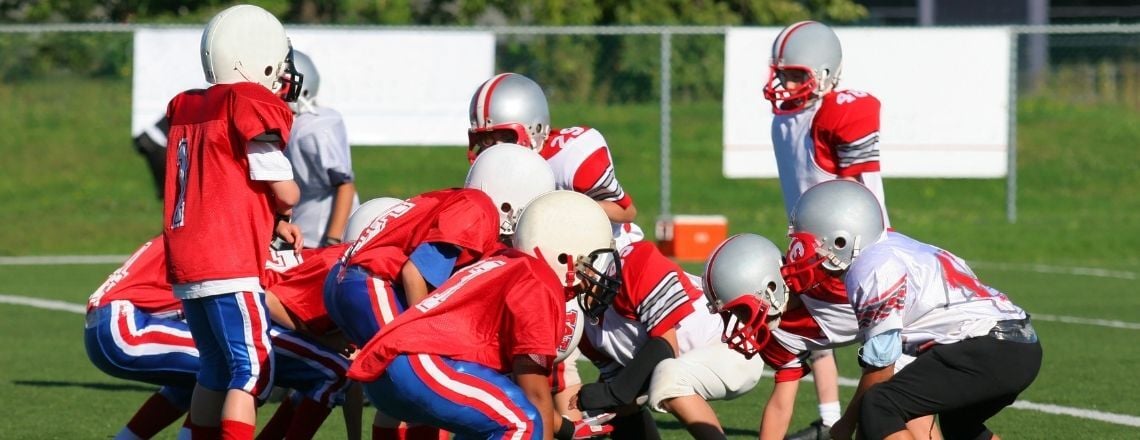 a team of boys playing football on a football field