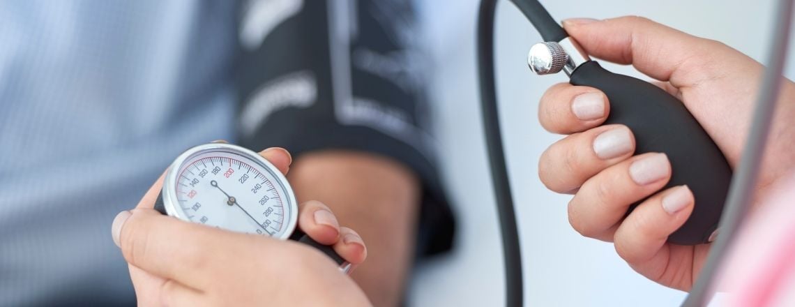 medical professional using a blood pressure cuff on a patient