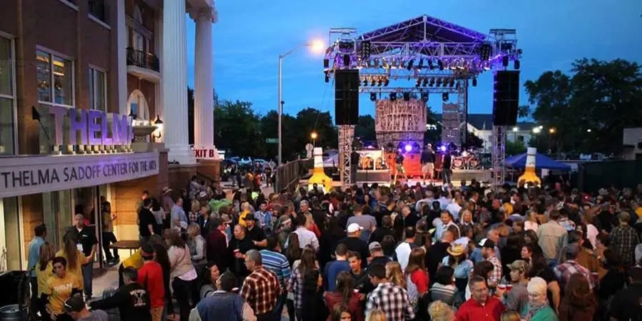 A large crowd enjoys an outdoor concert outside the Thelma Sadoff Center for the Arts in Fond du Lac, Wisconsin.