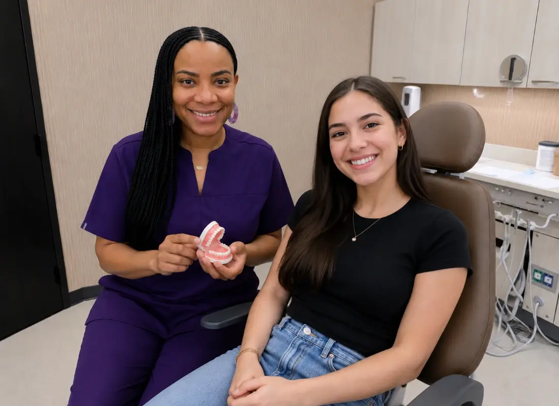 Oral surgeon smiling with patient and teeth model